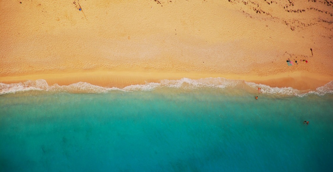 Aerial shot of a beach with blue water