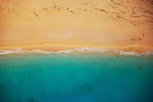 Aerial shot of a beach with blue water