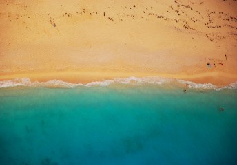 Aerial shot of a beach with blue water