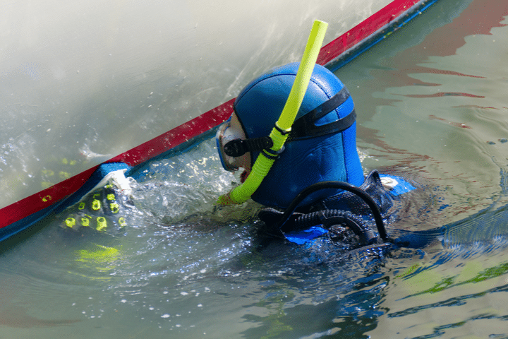 cleaning a boat in the water