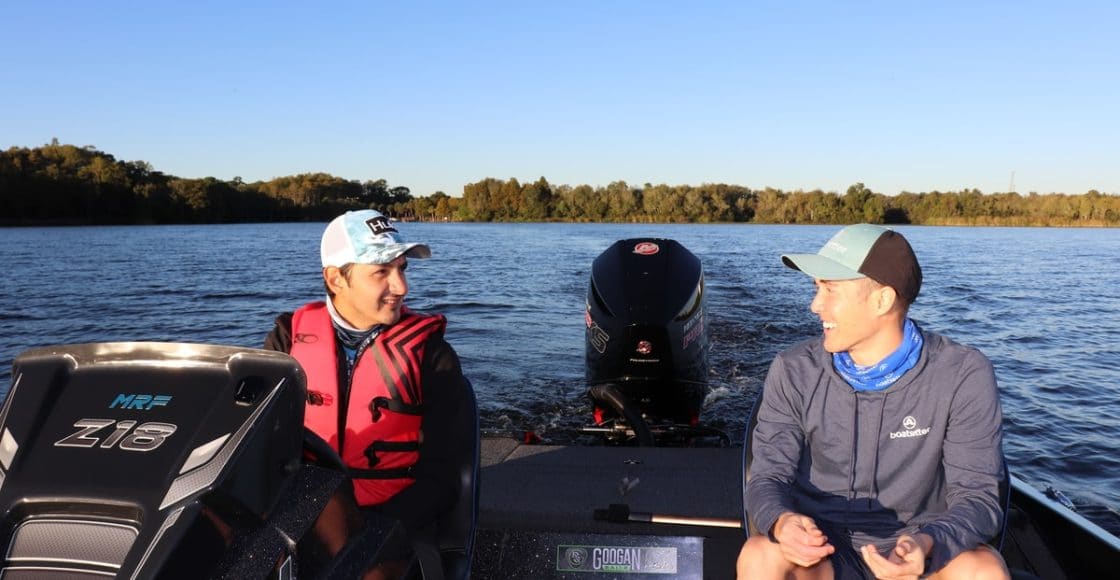 two fishers talking in bass fishing boat