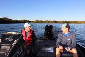 two fishers talking in bass fishing boat