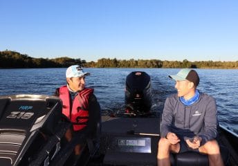 two fishers talking in bass fishing boat