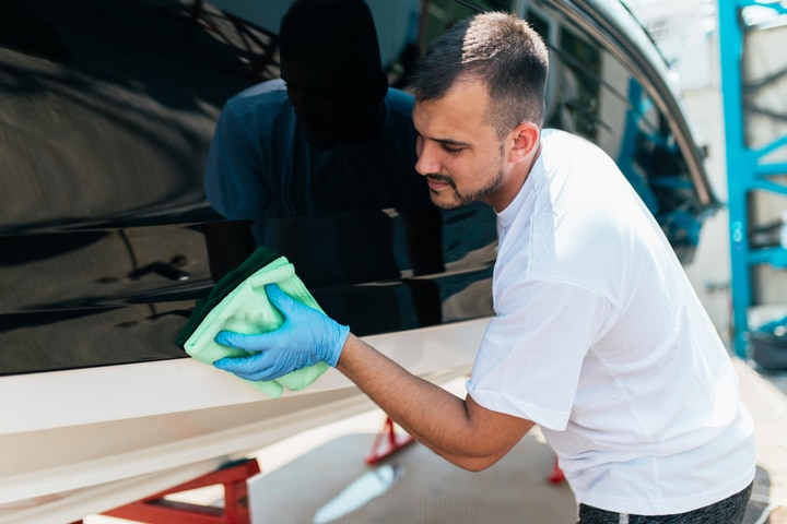 Waxing boat exterior.