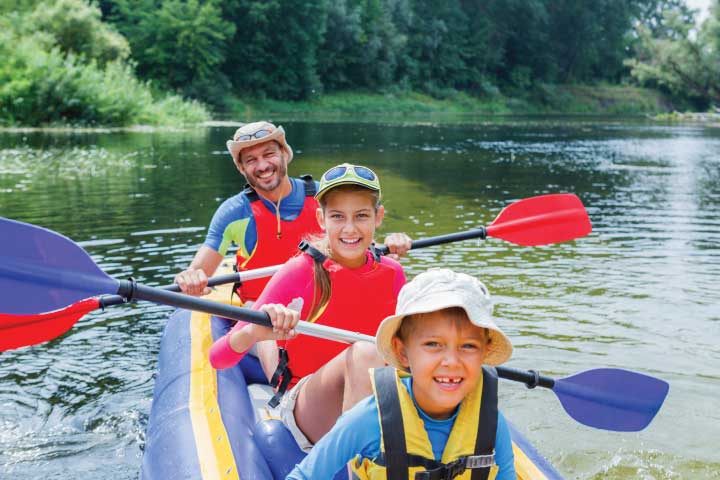 Kayaking wearing life jackets.