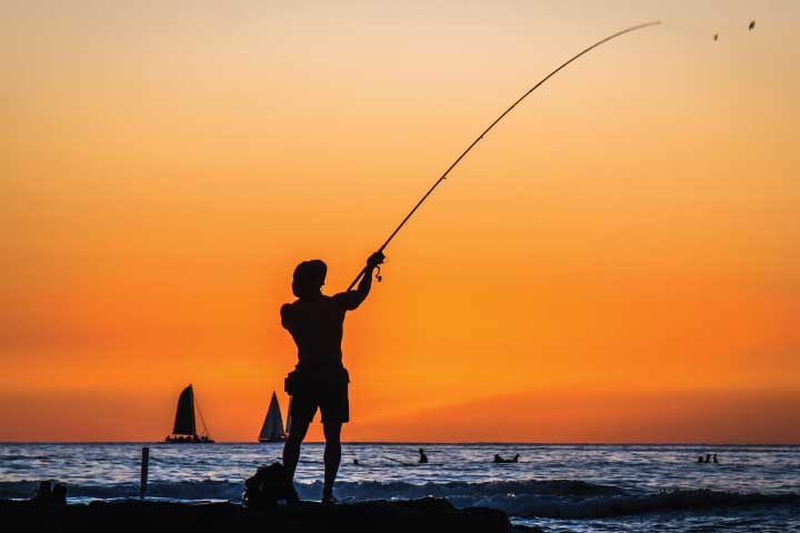 Fishing at Waikiki Beach, Honolulu, Hawaii.