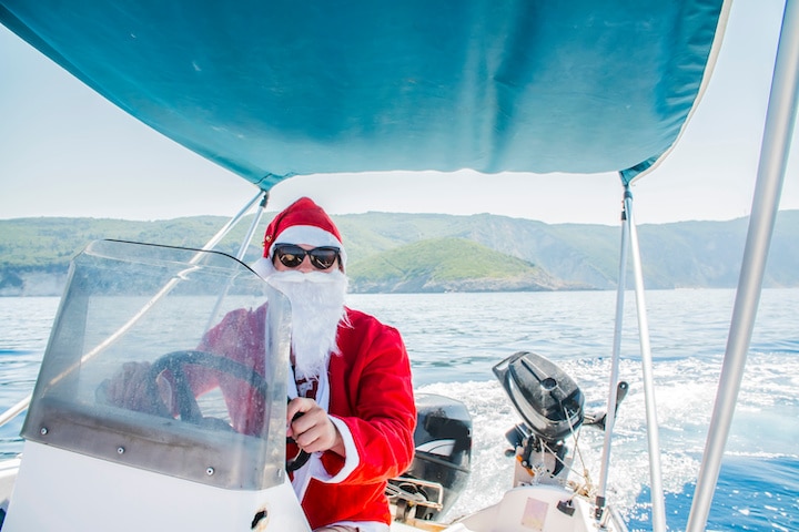 Santa Claus driving a boat on the sea