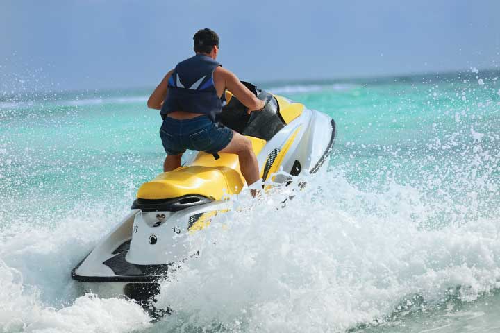 Standing on a Jet Ski.