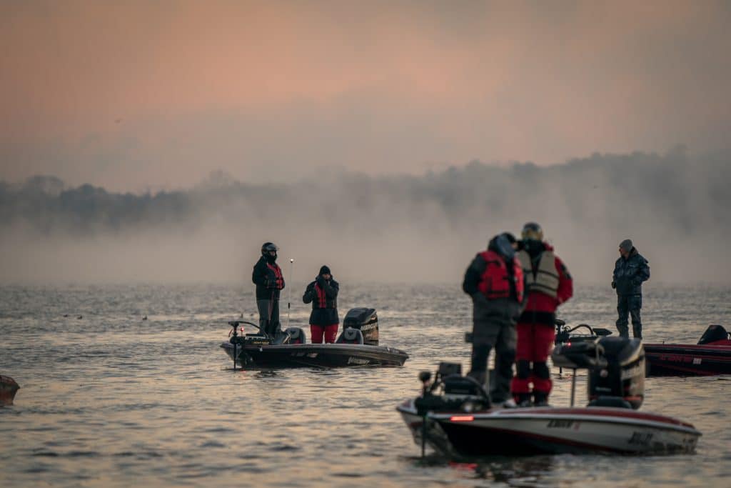 Anglers wait on their boats for the start of a fishing tournament