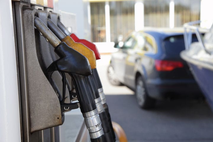 Fueling boat at gas station on land.