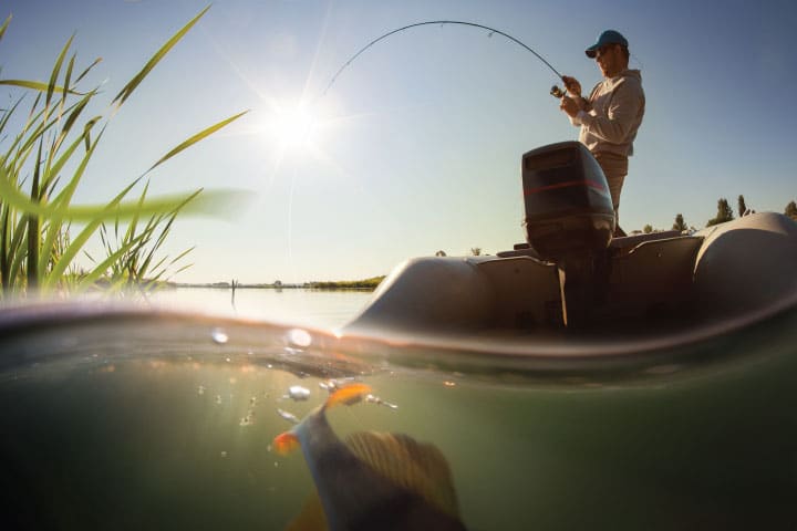 Fisherman fishing from boat.