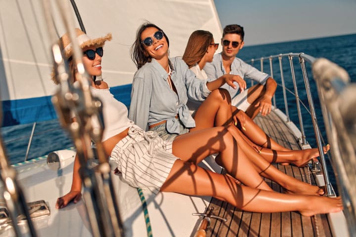 A group of friends on a yacht at sunset.