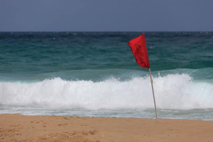 Red flag wind warning on a beach.