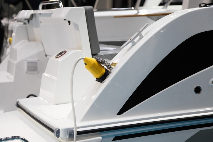 An electric boat charging at the dock.