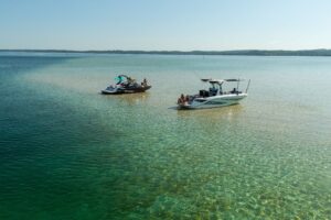 Two boats on a sandbar.