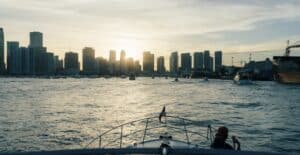 Enjoy a serene boat ride with Miami's iconic skyline at sunset, offering a perfect urban escape.