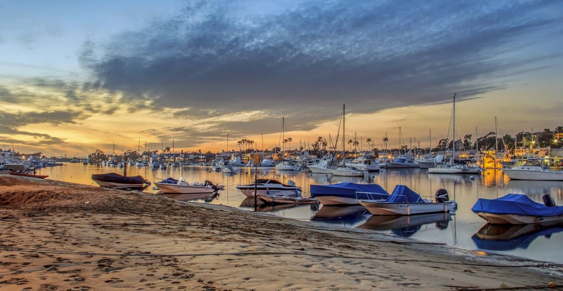 boats on beach during sunset