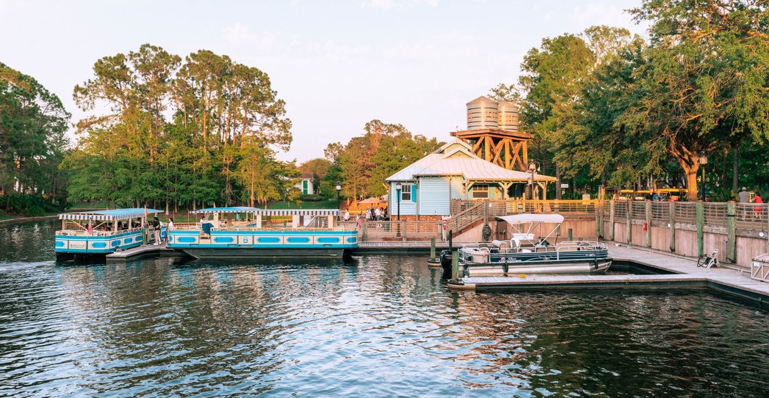 Peaceful scene of boats docked at Port Orleans Riverside during sunset.